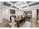 Open concept dining room with coffered ceiling, hardwood floors, and view of the kitchen at 2981 Thurman Dairy Loop, Wake Forest, NC 27587