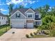 Charming two-story home boasts a large driveway, well-manicured landscaping, and an attached two-car garage at 2981 Thurman Dairy Loop, Wake Forest, NC 27587