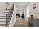 Elegant foyer featuring hardwood floors, staircase with iron railings, and stylish decor at 2981 Thurman Dairy Loop, Wake Forest, NC 27587