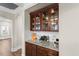 Butler's pantry featuring custom cabinetry, granite countertop, and wine rack at 2981 Thurman Dairy Loop, Wake Forest, NC 27587