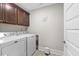 Functional laundry room with modern washer and dryer and upper cabinets for storage at 2981 Thurman Dairy Loop, Wake Forest, NC 27587