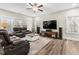 Spacious living room with hardwood floors, ceiling fan, and large windows at 2981 Thurman Dairy Loop, Wake Forest, NC 27587