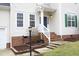 Inviting front entrance with brick steps, a charming storm door, and well-maintained landscaping at 3010 Shopton Dr, Apex, NC 27502