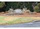 A decorative stone sign marks the entrance to Woodridge, enhancing the neighborhood's appeal at 3010 Shopton Dr, Apex, NC 27502