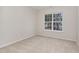 Clean bedroom space featuring neutral carpet, a window view, and ample natural light at 3020 Buttonwood Ln, Clayton, NC 27520