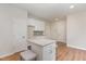 Bright and airy kitchen with white cabinetry, granite countertops, an island, and modern fixtures at 3020 Buttonwood Ln, Clayton, NC 27520