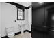 Small, clean bathroom with a toilet, sink, black accent and white tile at 318 W Lillington St, Angier, NC 27501