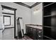 Bathroom with double sink, marble countertops, dark trim, and an adjacent bedroom at 318 W Lillington St, Angier, NC 27501