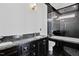 Bathroom with granite counter tops, black cabinets, a glass shower, and a soaking tub at 318 W Lillington St, Angier, NC 27501