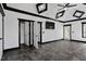 A large bedroom featuring neutral walls, a tray ceiling, a tv, and access to the outdoor patio at 318 W Lillington St, Angier, NC 27501