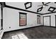 A large bedroom featuring neutral walls, a tray ceiling, and a window providing natural light at 318 W Lillington St, Angier, NC 27501
