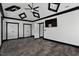 A large bedroom featuring neutral walls, a tray ceiling, and multiple doors providing lots of space at 318 W Lillington St, Angier, NC 27501