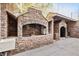 Custom outdoor stone kitchen featuring a large grill and dining area on a concrete patio at 318 W Lillington St, Angier, NC 27501
