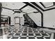 Impressive foyer with black and white tiled floors, a glass railed staircase, and modern lighting at 318 W Lillington St, Angier, NC 27501