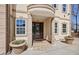 Home's front entrance has elegant columns, a detailed door and an inviting tiled walkway at 318 W Lillington St, Angier, NC 27501