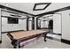 Spacious game room includes a pool table, sleek black trim, and modern ceiling design at 318 W Lillington St, Angier, NC 27501