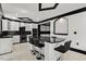 Modern kitchen with sleek black and white cabinets, granite countertops and seating at the island at 318 W Lillington St, Angier, NC 27501