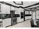 Another view of the kitchen featuring an oven, white cabinets, and contrasting black countertops at 318 W Lillington St, Angier, NC 27501