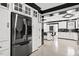 Open kitchen layout with a refrigerator and bar seating area at 318 W Lillington St, Angier, NC 27501