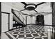 Unique staircase with glass side panels in living room with checkered floors at 318 W Lillington St, Angier, NC 27501