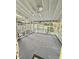 Carpeted screened porch with decorative latticework and outdoor views of a fenced yard and trees at 325 Old Salem Rd, Roxboro, NC 27573