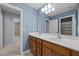 Bathroom featuring a dual sink vanity, large mirror, and soft blue walls for a bright, airy feel at 401 Euphoria Cir, Cary, NC 27519