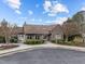 Exterior of community clubhouse featuring elegant architecture, well-manicured landscaping, and ample parking at 401 Euphoria Cir, Cary, NC 27519