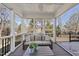 Relaxing screened porch with a comfortable couch and outdoor views at 405 Chandler Grant Dr, Cary, NC 27519