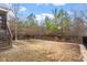 A large backyard with a wooden fence, trees, and a grassy area at 4909 Jelynn St, Raleigh, NC 27616