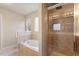 Bathroom featuring a shower with tile surround, a bathtub, and a window for natural light at 4909 Jelynn St, Raleigh, NC 27616