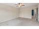 Carpeted bedroom featuring a ceiling fan and a doorway leading to another room at 4909 Jelynn St, Raleigh, NC 27616