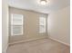 This bedroom has carpeted floors, a neutral paint color and two windows at 4909 Jelynn St, Raleigh, NC 27616