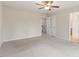 Bedroom with neutral carpet flooring and a ceiling fan; showcases access to closet and bathroom at 4909 Jelynn St, Raleigh, NC 27616