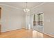 Bright dining room with hardwood floors, chandelier, and sliding doors to outdoor patio at 4909 Jelynn St, Raleigh, NC 27616