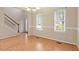 Light-filled dining room with hardwood floors, wainscoting, and a modern chandelier at 4909 Jelynn St, Raleigh, NC 27616