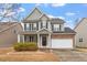 Charming two-story home featuring gray siding, black shutters, covered porch, and attached two-car garage at 4909 Jelynn St, Raleigh, NC 27616
