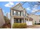 Attractive two-story home with covered front porch, light gray siding, and well-maintained landscaping at 4909 Jelynn St, Raleigh, NC 27616