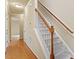 Bright hallway with hardwood floors, leading to a carpeted staircase with wooden railing at 4909 Jelynn St, Raleigh, NC 27616