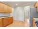 Well-lit kitchen featuring light wood cabinetry, granite countertops, and stainless steel appliances at 4909 Jelynn St, Raleigh, NC 27616