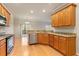 Bright kitchen with stainless steel appliances, granite countertops, and wooden cabinets at 4909 Jelynn St, Raleigh, NC 27616