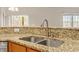 Close up of stainless steel kitchen sink and granite countertops, adding elegance to the space at 4909 Jelynn St, Raleigh, NC 27616