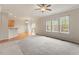Spacious living room with carpet, natural light from multiple windows, and ceiling fan at 4909 Jelynn St, Raleigh, NC 27616