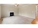 Comfortable living room featuring a fireplace, soft carpet, and access to a hallway at 4909 Jelynn St, Raleigh, NC 27616