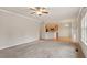 Open-concept living room with neutral carpet, view of the kitchen, and abundant light at 4909 Jelynn St, Raleigh, NC 27616