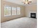 Bright living room with fireplace, natural light from windows, and ceiling fan at 4909 Jelynn St, Raleigh, NC 27616