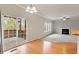 Open living area showcasing hardwood flooring, fireplace, and access to outdoor patio at 4909 Jelynn St, Raleigh, NC 27616
