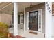 Inviting front porch showcasing a swing, sidelights, and decorative door with house number at 4909 Jelynn St, Raleigh, NC 27616