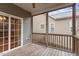 An enclosed porch area featuring a wooden floor and dark wood railing at 4909 Jelynn St, Raleigh, NC 27616