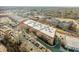 Wide aerial view of brick buildings with a parking lot and city skyline at 500 N Duke St # 55-103, Durham, NC 27701