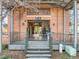 Close-up of a building 55 entrance with brick facade, metal awning and steps at 500 N Duke St # 55-103, Durham, NC 27701